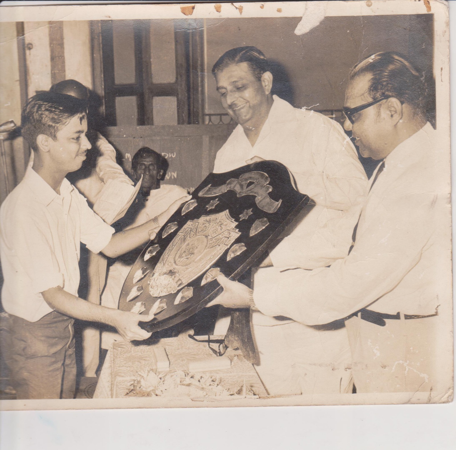 Presenting a heritage shield at a felicitation