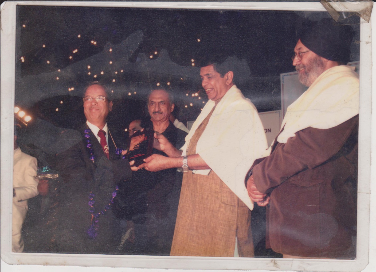 Felicitated with plaque and shawl
